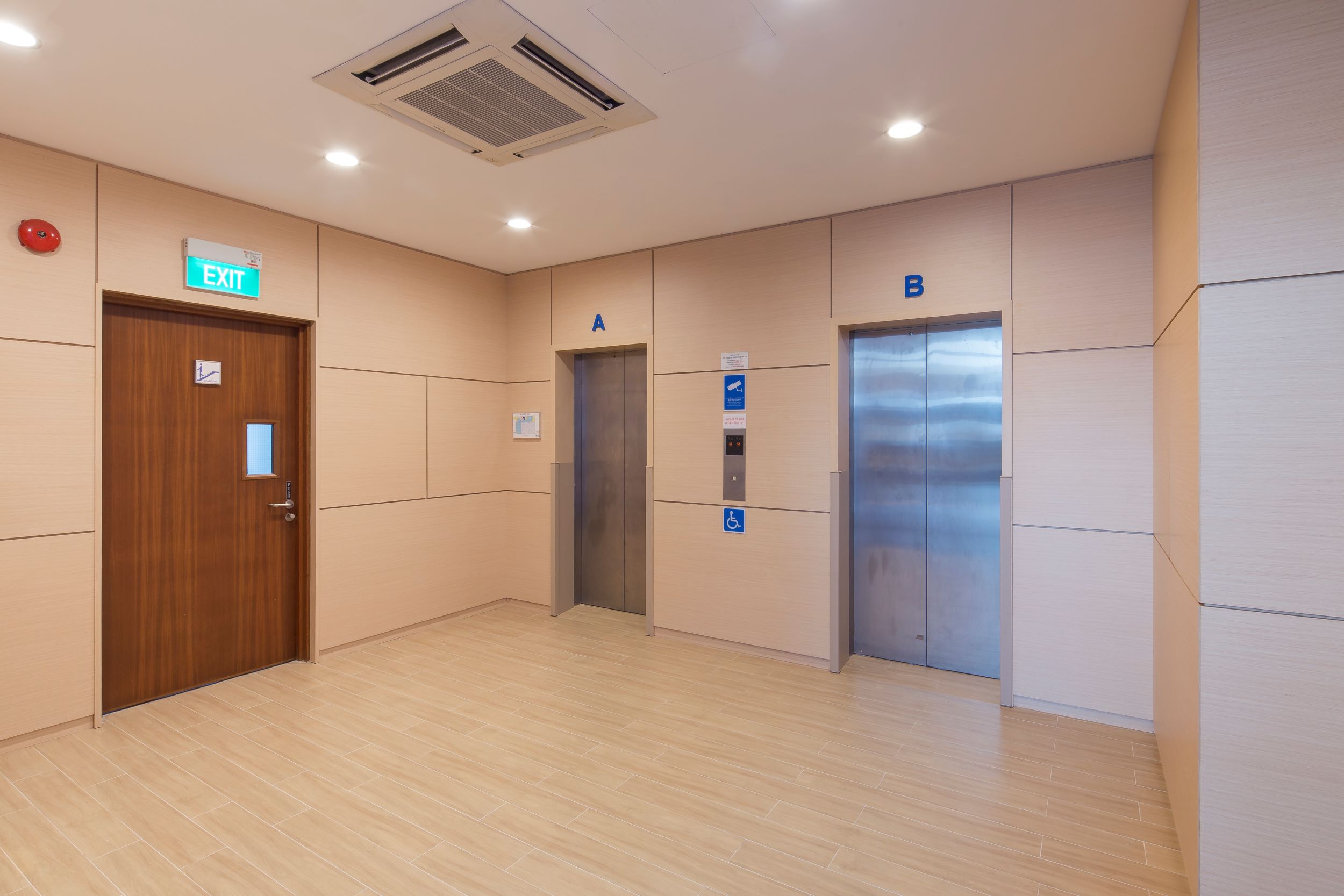 Woodland hallway with two elevators marked A and B, an exit door design